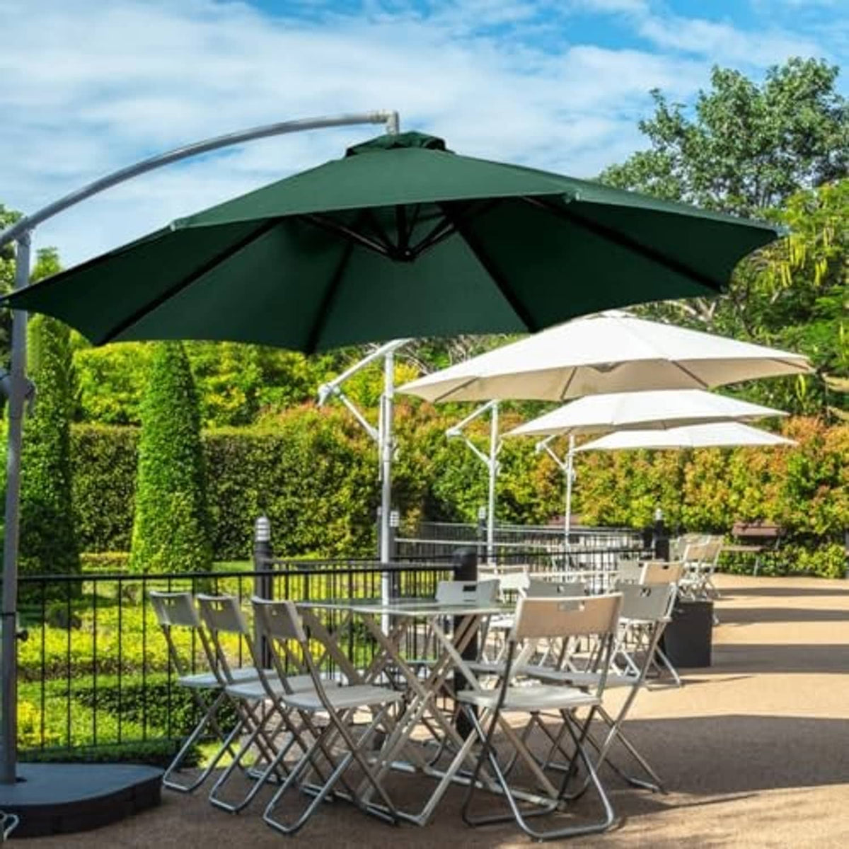 Dark green 6-rib patio umbrella with open canopy over outdoor dining area