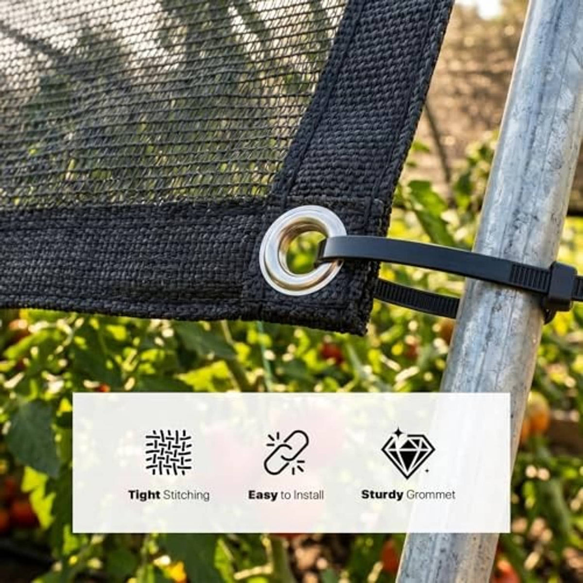 Black shade cloth tarp edge with metal grommet and strap securing to a pole