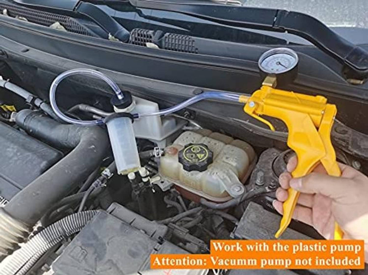 Brake bleeder adapter kit in engine bay with clear tubing and plastic fluid reservoir