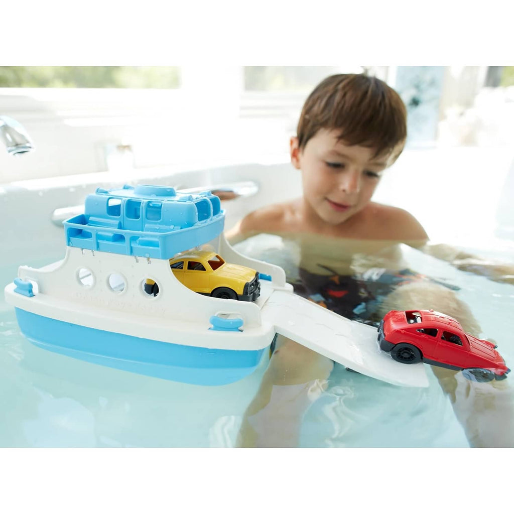 Bathtub ferry toy floating with blue ramp, holding a yellow and red mini car