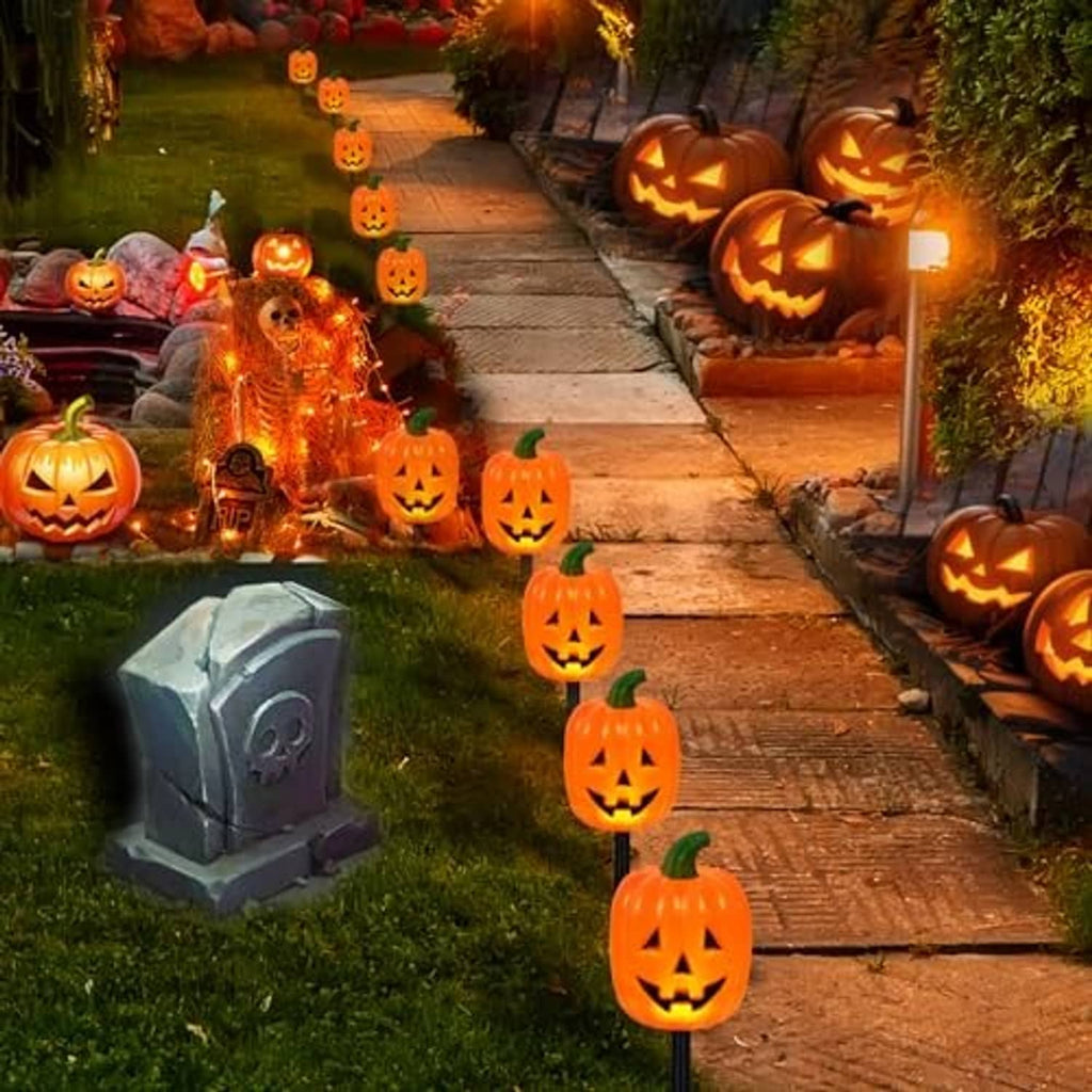 Jack-o'-lantern pumpkin stake lights lining a garden walkway