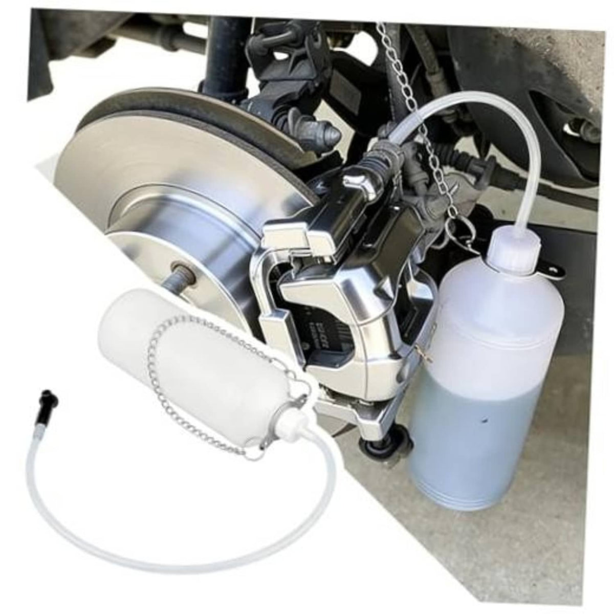 Hangable brake bleeder bottle kit with white bottle and clear hose near car brakes