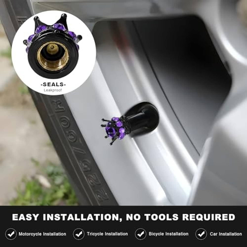 Purple jeweled black crown tire valve stem cap with brass threaded inlet, close-up installed