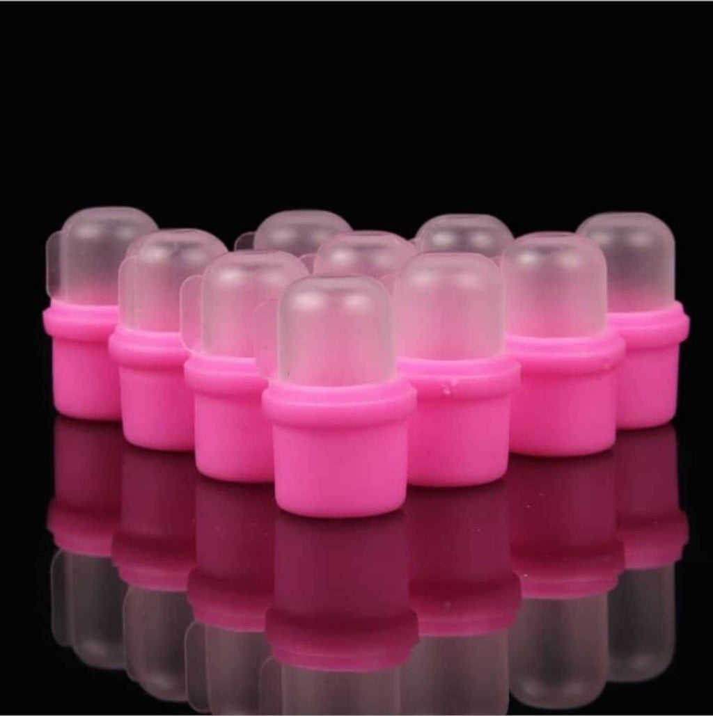 Grouped pink wearable nail soak soakers with clear domed tops
