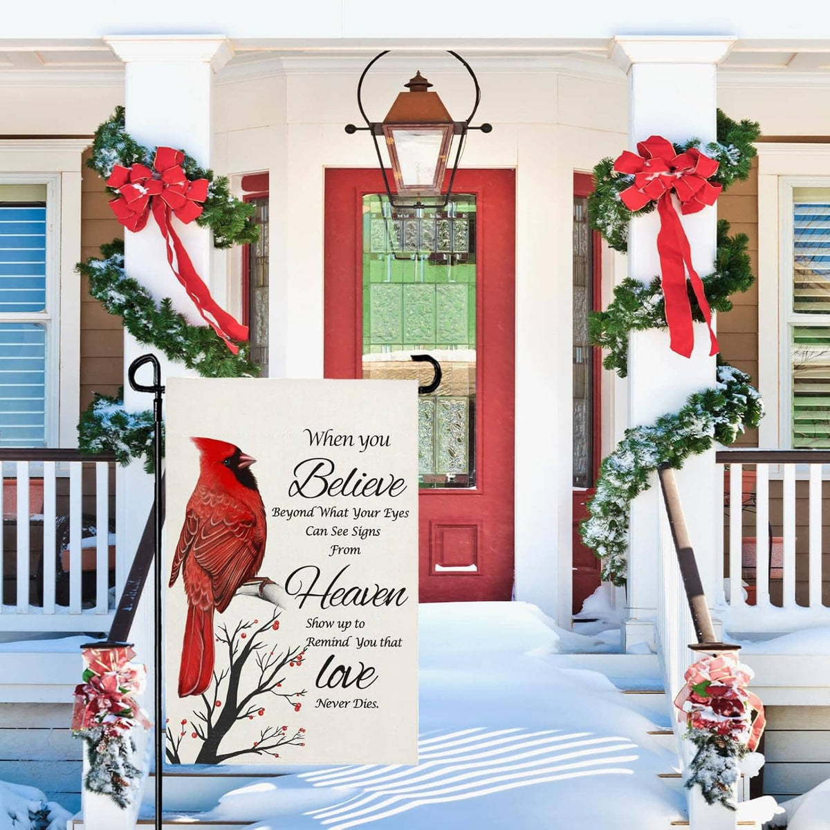 Cardinal winter yard flag with “Believe” and “Heaven” text on white fabric