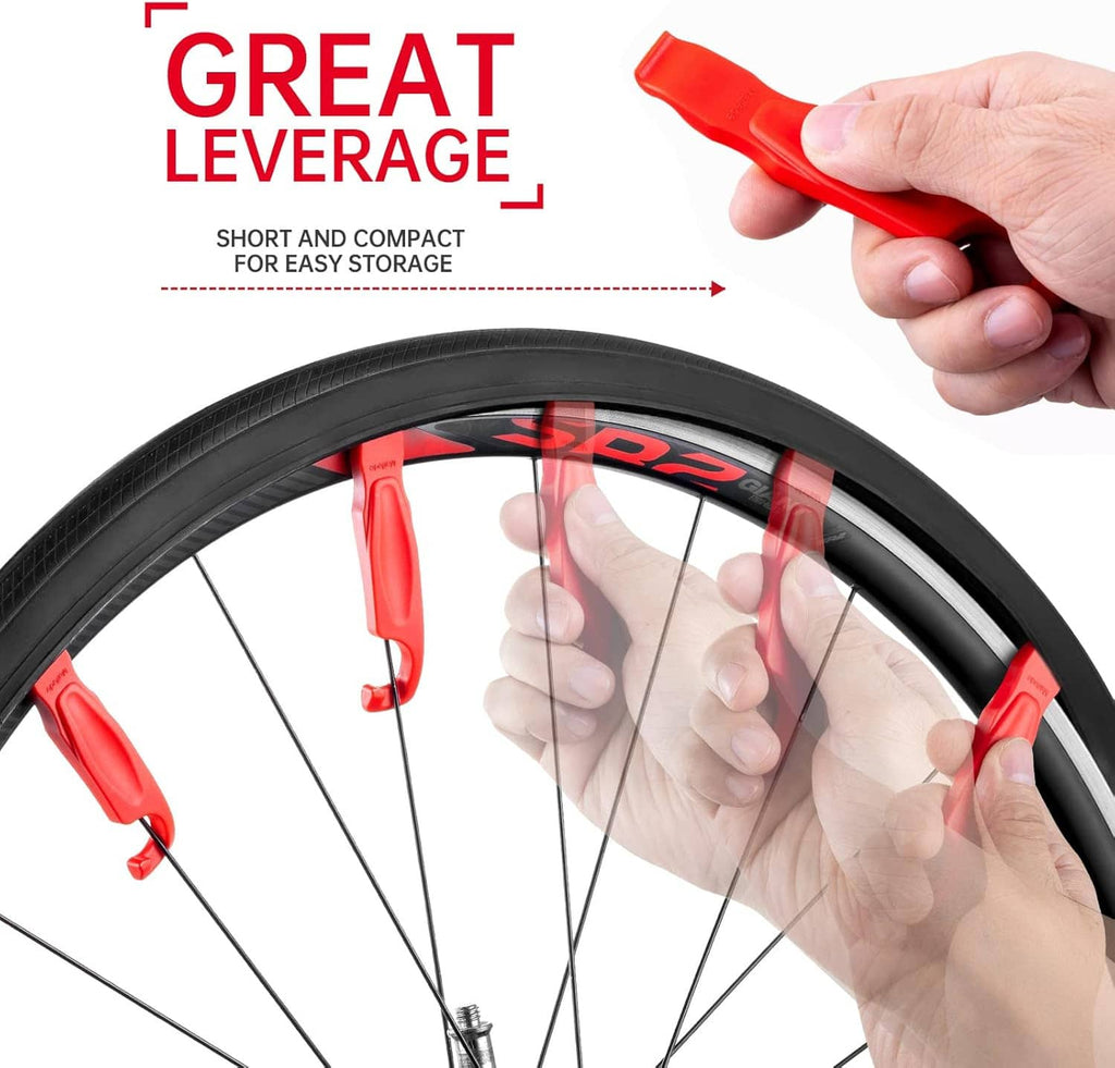 Red tire lever held by hand for removing tire from wheel rim.