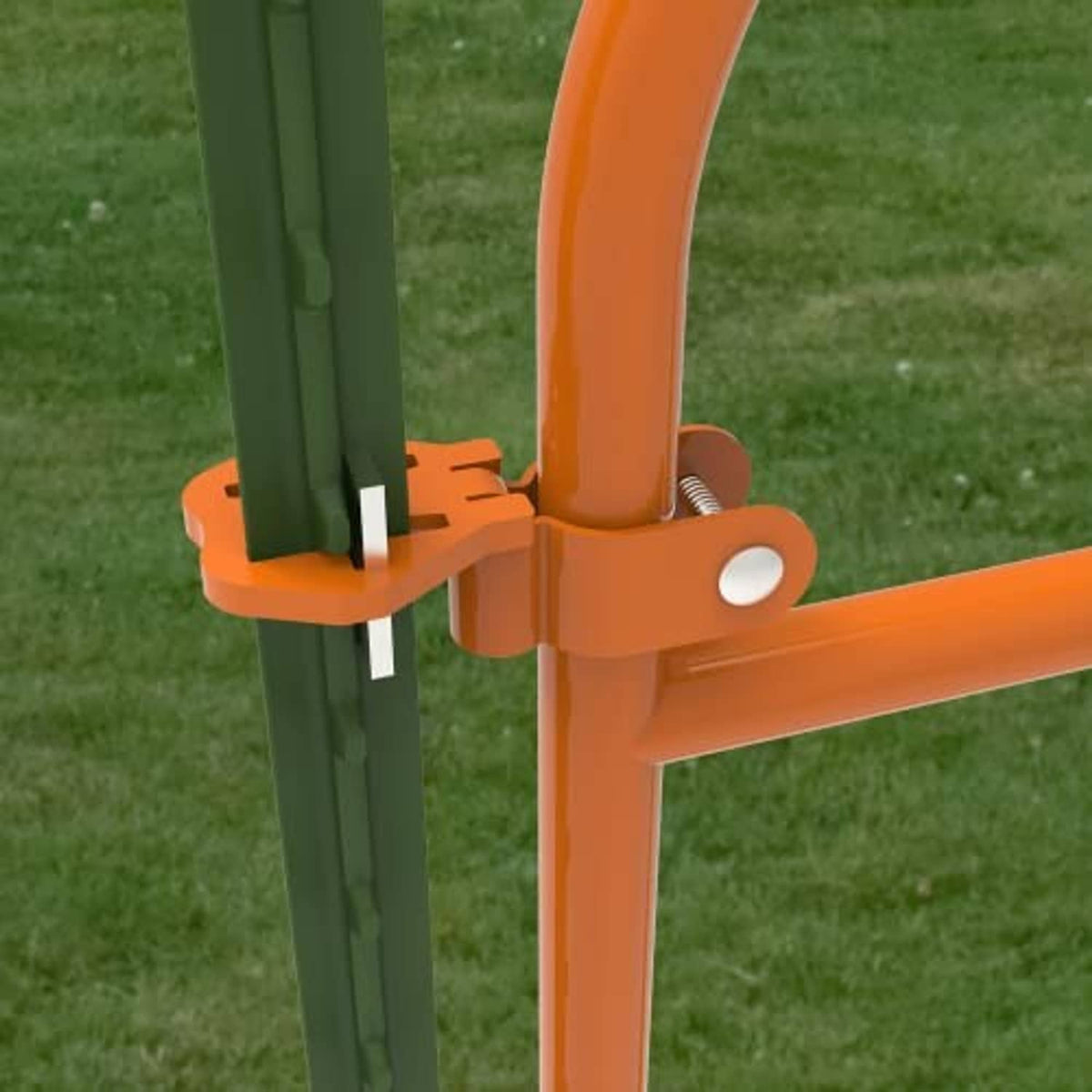 Close-up of orange gate hinge bracket with pin and spring on a green T post