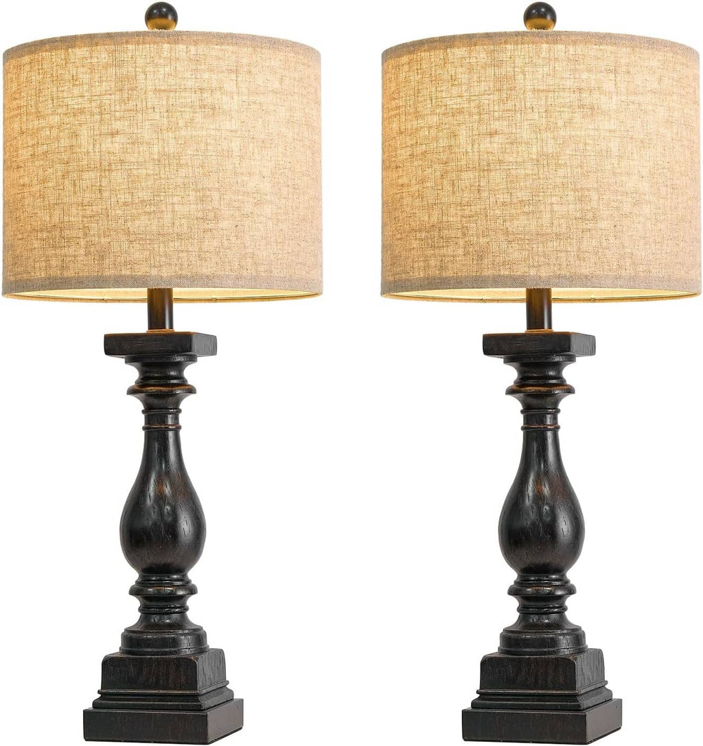 Two beige-shade table lamps with dark turned pedestal bases, front view