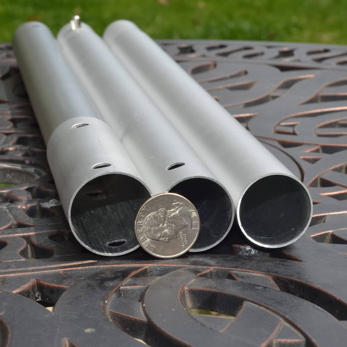 Gray anodized aluminum pool pole tube ends with open holes and one cap