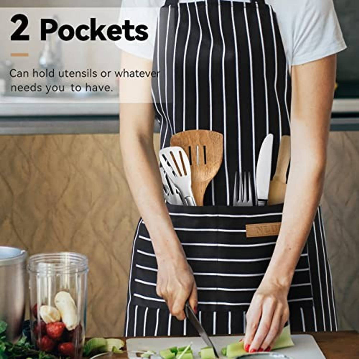 Dark striped apron with front pockets holding kitchen utensils