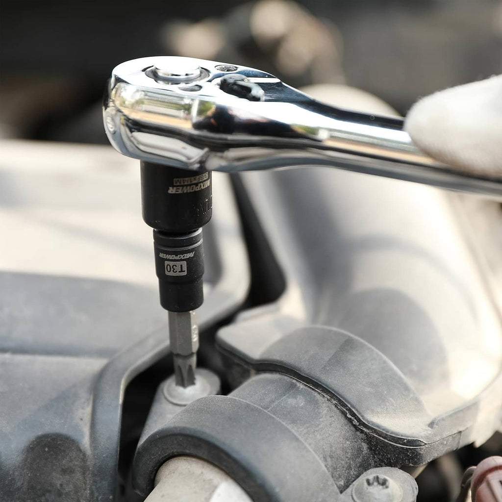 Torx bit socket engaged on a vehicle wheel lug nut with a ratchet handle