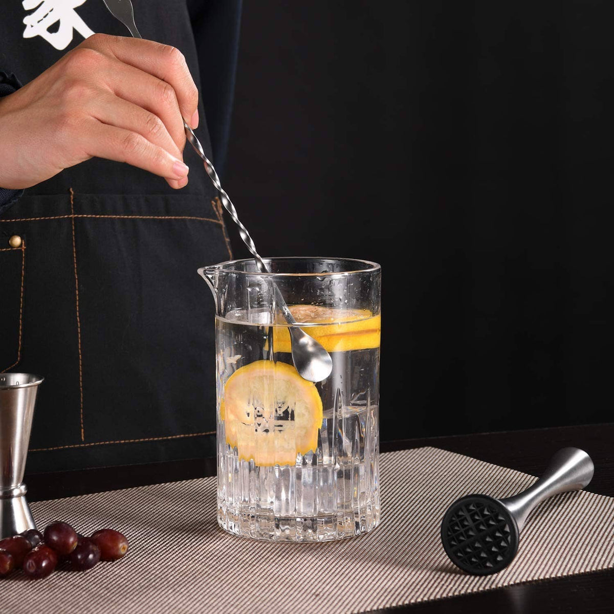 Stainless steel mixing spoon with twisted handle and black tip for stirring