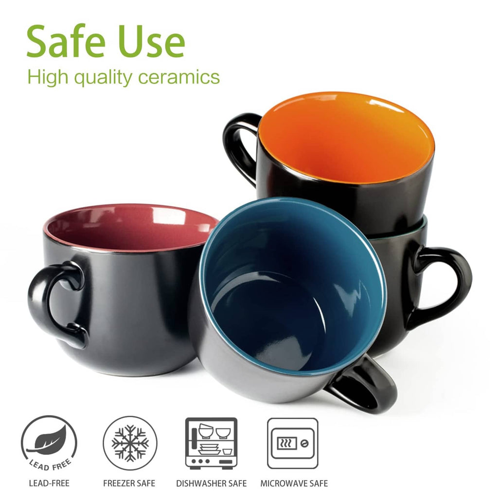 Assorted jumbo soup mugs with handles, black exterior and orange, red, and blue interiors