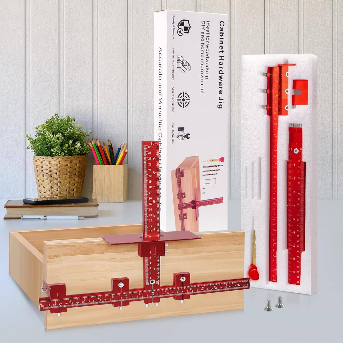 Cabinet handle jig kit with red alignment frame, ruler, bits, and mounting hardware