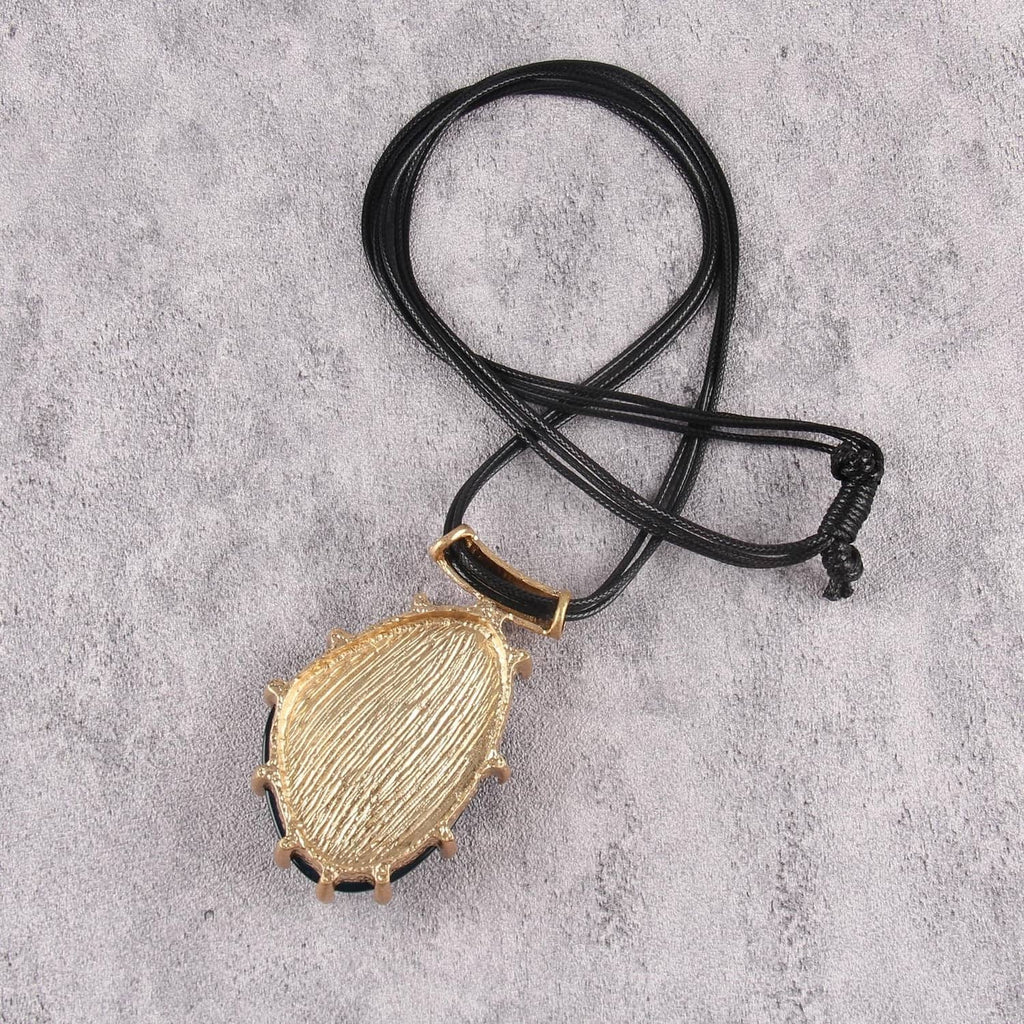 Black faux leather cord necklace with green teardrop pendant charm and cord tie