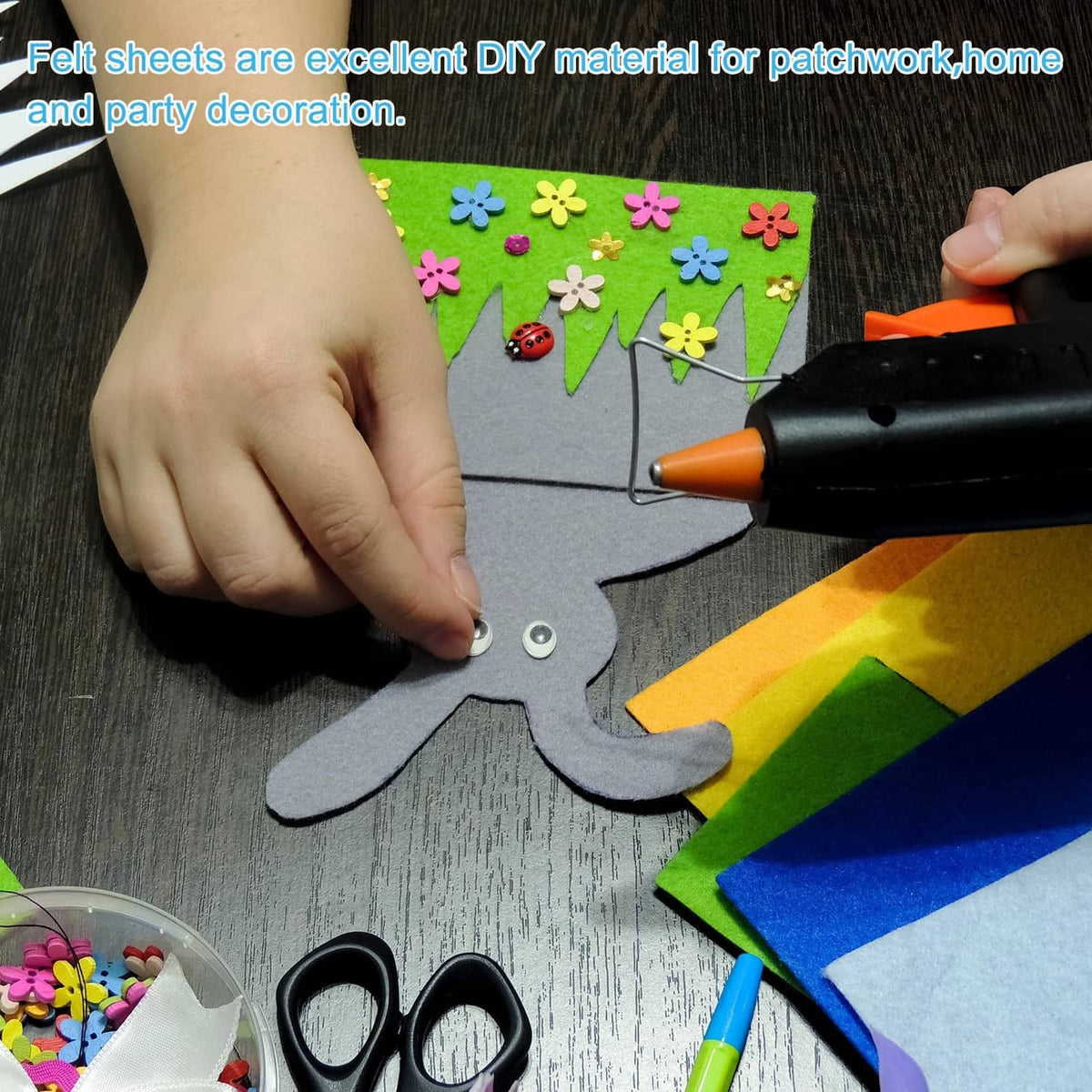 Black felt sheet used for DIY crafts, round piece being cut