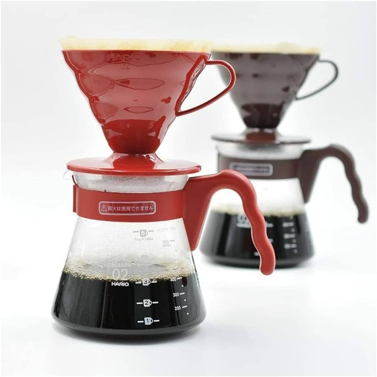 Red pour-over dripper and glass coffee carafe with scale markings