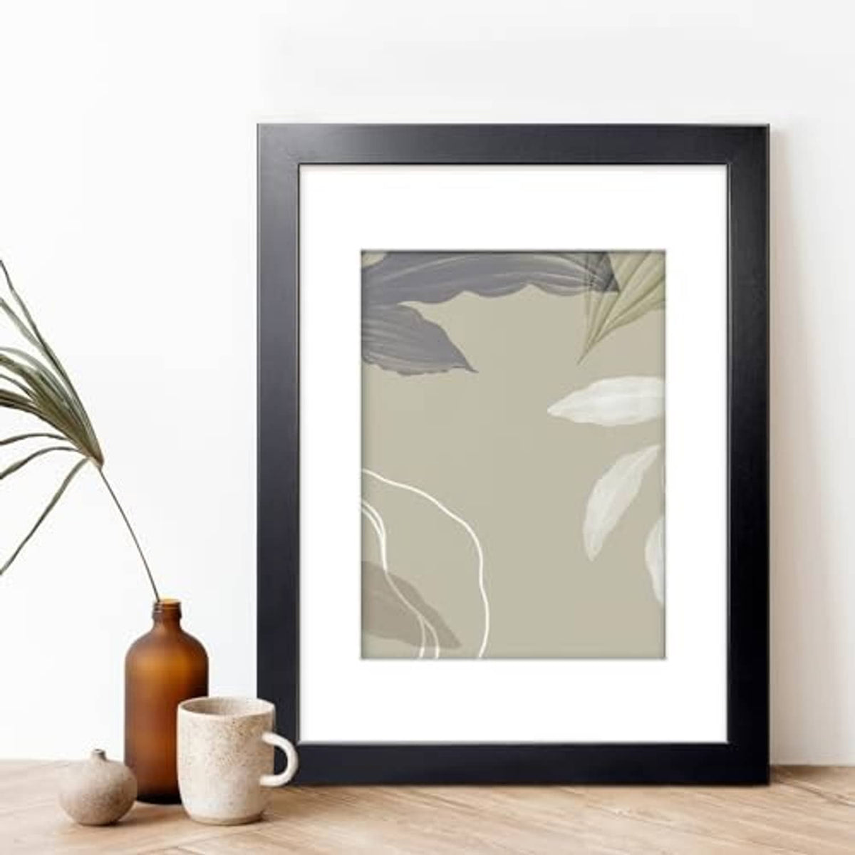 Black 11x14 picture frame holding a light-toned botanical print