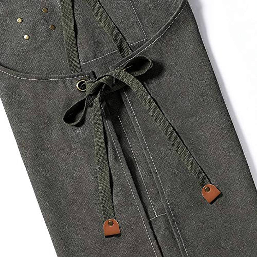 Grey canvas apron with neck tie, stitched seams, and leather tag accents
