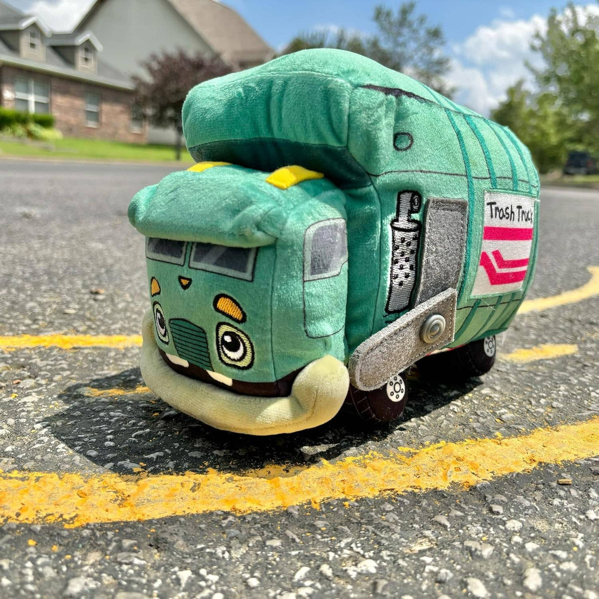 Green trash truck plush side view with gray door and red stripe on the back