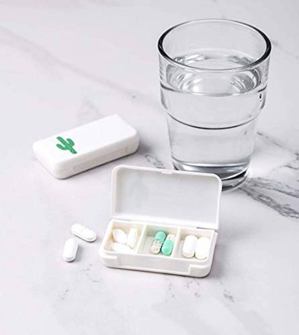 Small white pill organizer with divided tray and cactus icon, tablets and capsules inside