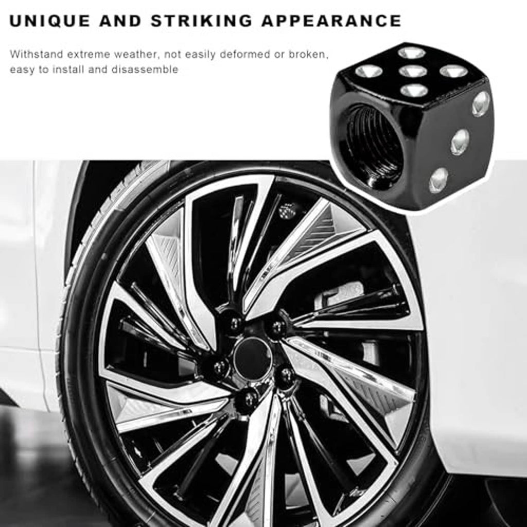 Black dice-shaped valve stem cap with silver dots and threaded opening on a wheel valve
