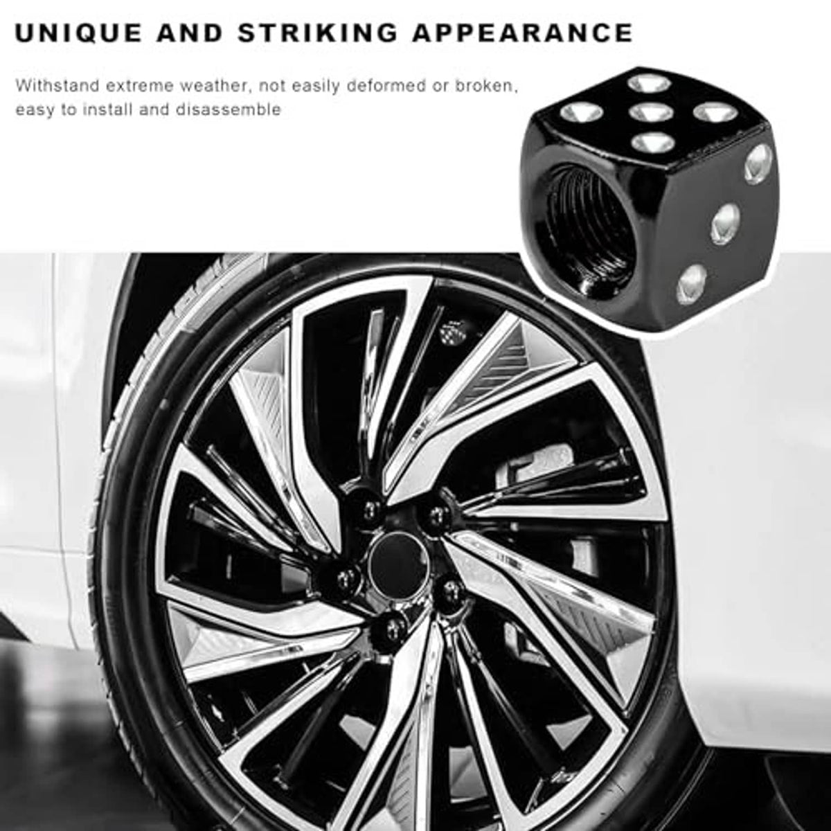 Black dice-shaped valve stem cap with silver dots and threaded opening on a wheel valve