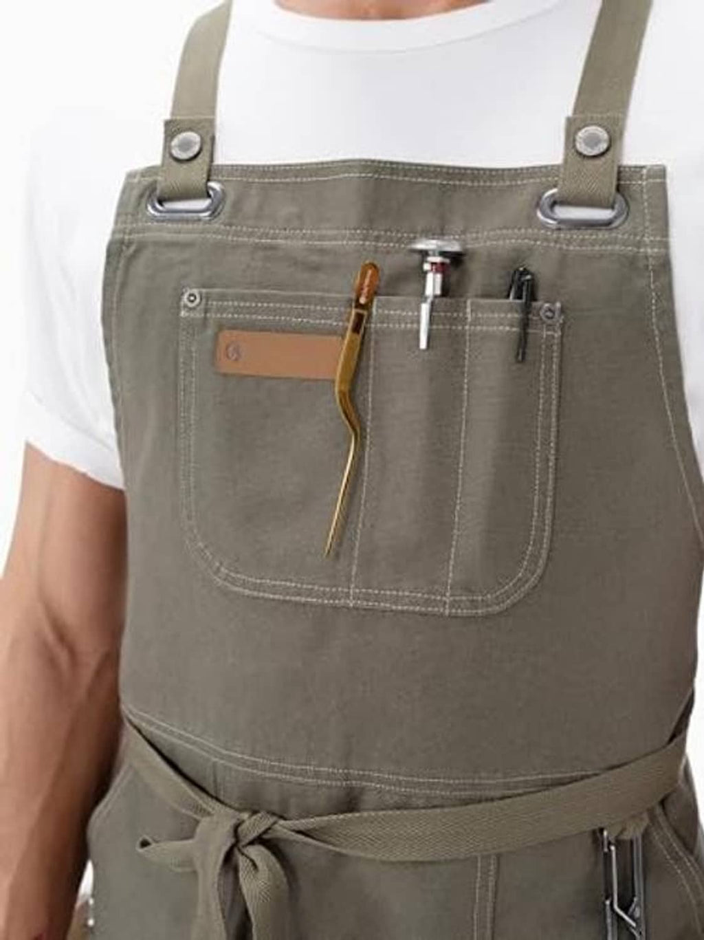 Olive apron close-up with front organizer pocket and hanging tool attachment loops