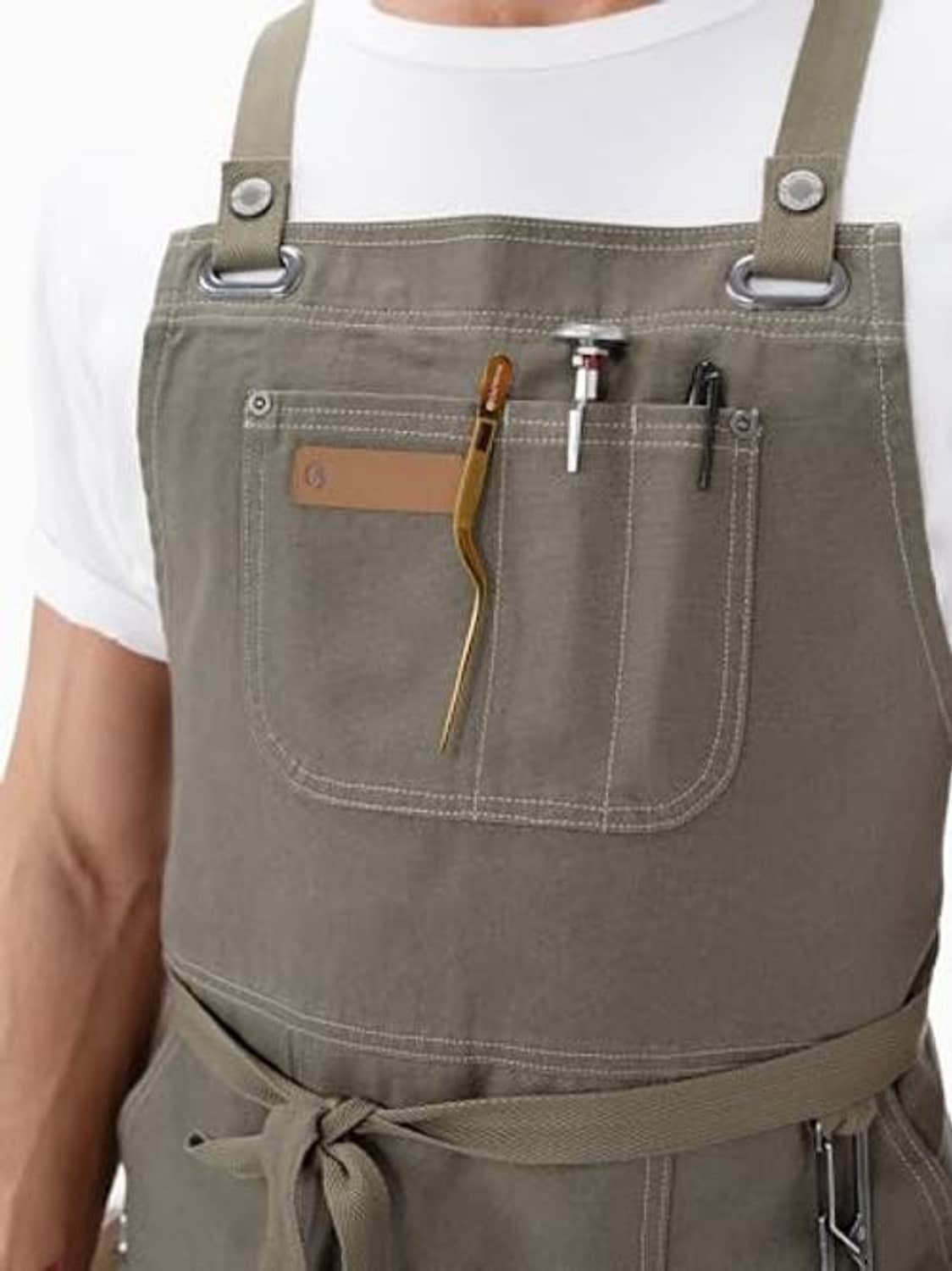 Olive apron close-up with front organizer pocket and hanging tool attachment loops