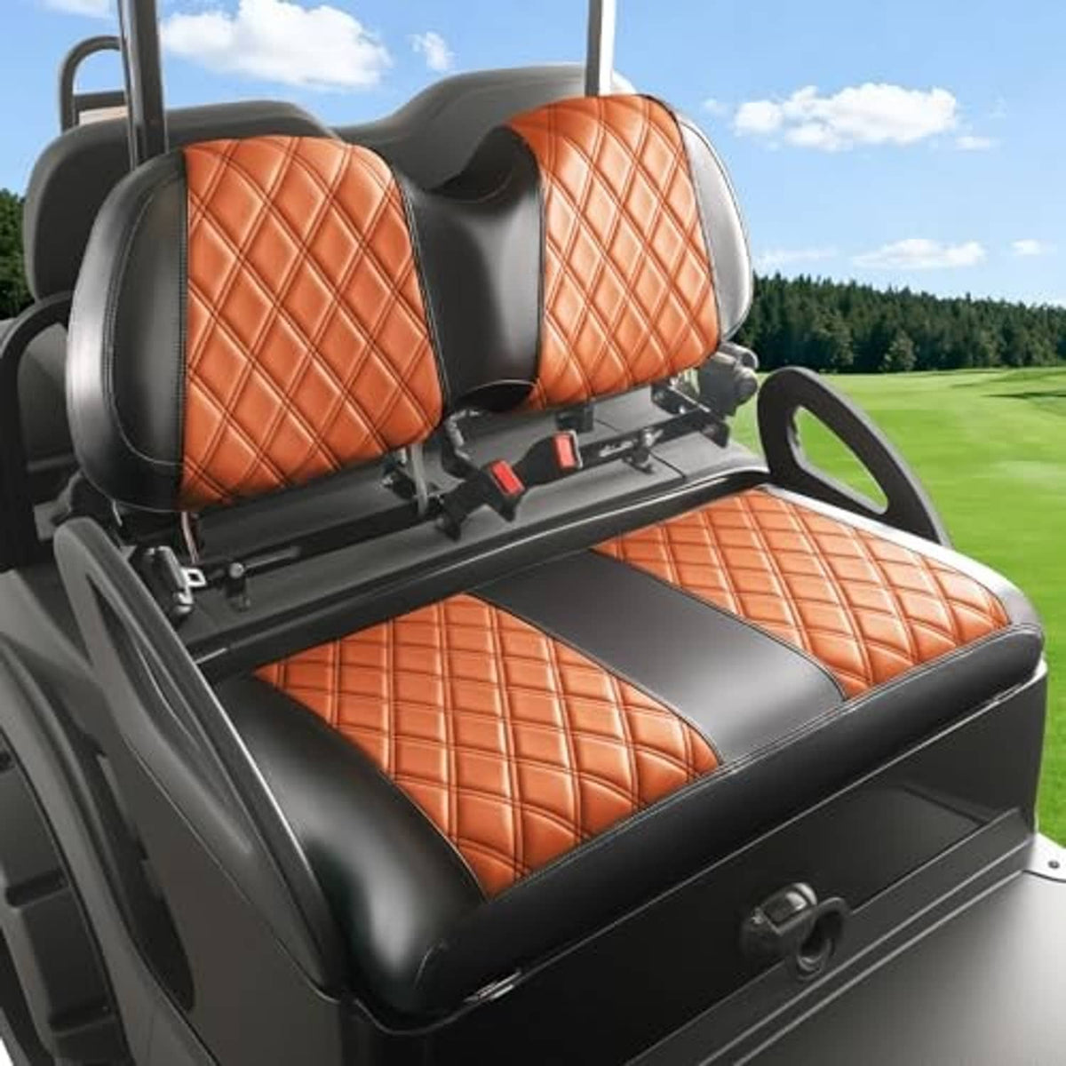 Two orange diamond-stitched seat covers with black trim on a golf cart bench