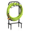 Freestanding garden hose holder with lime green hose and black metal stand, four hooks