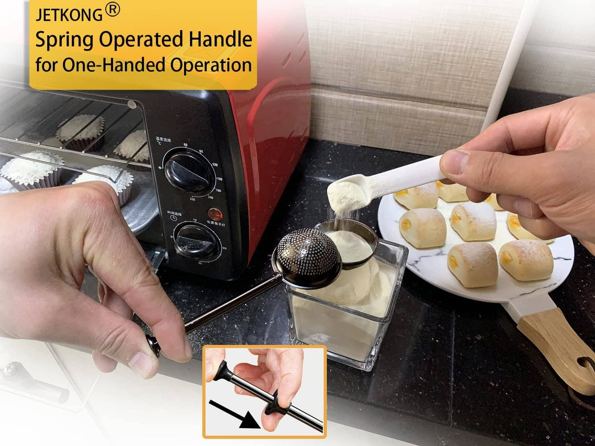 Black powdered sugar shaker duster with spring-operated handle and perforated cup