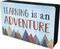 Magnetic whiteboard eraser tray with “Learning is an Adventure” mountain artwork