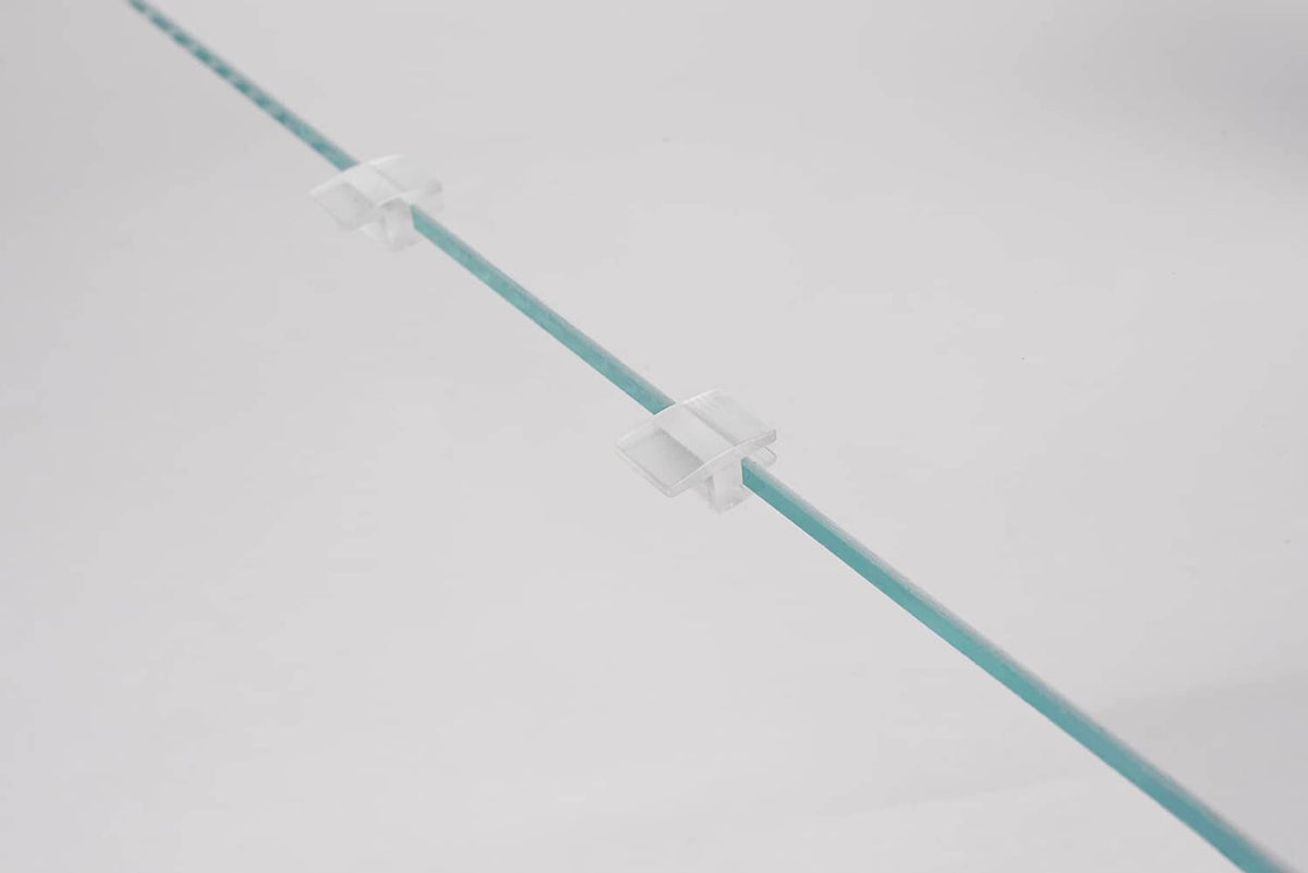 Clear acrylic lid edge spacer strip with white clips along the length