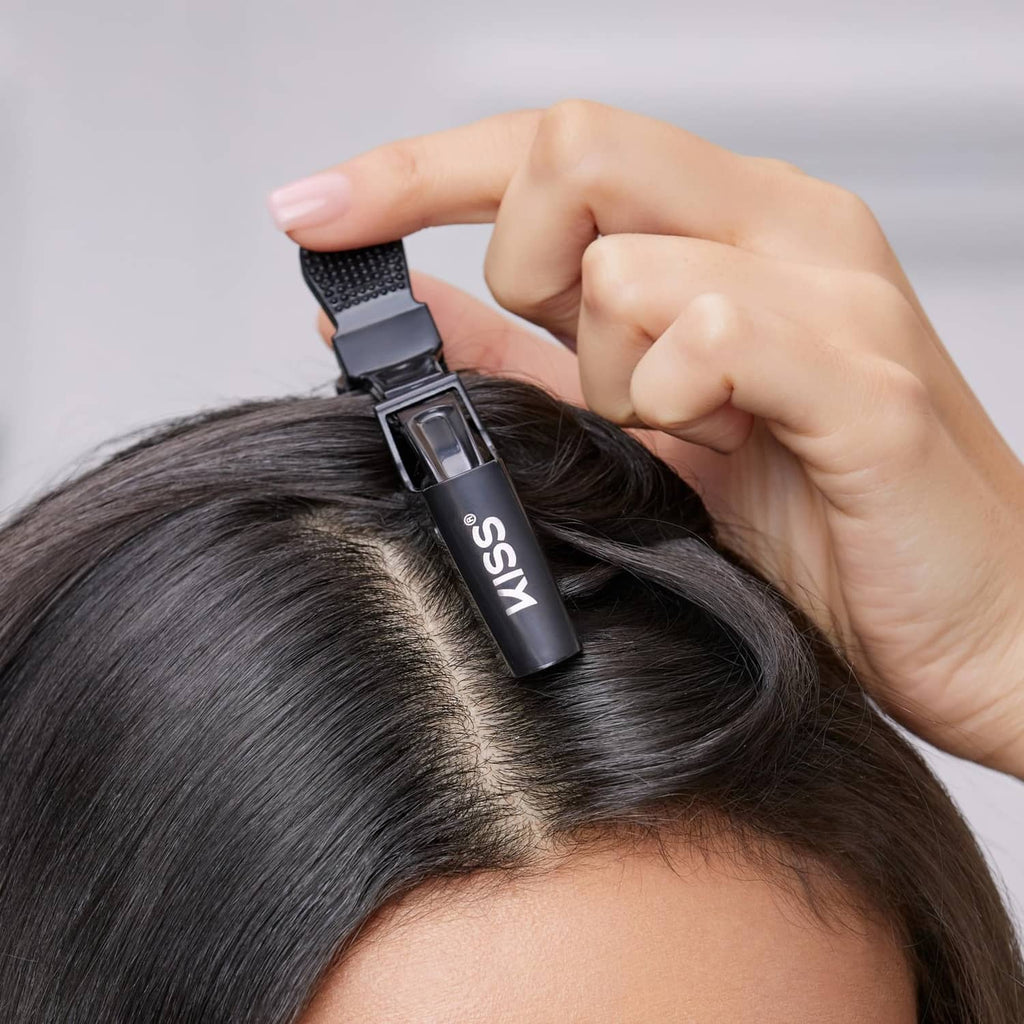 Black hair clip attachment held on a section of dark hair