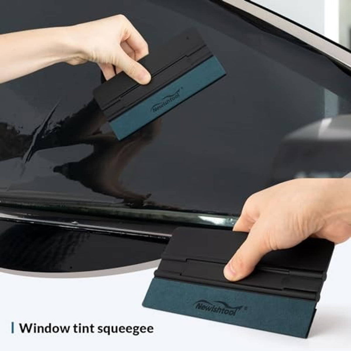 Black window tint vinyl squeegee with felt pad, applied on glass