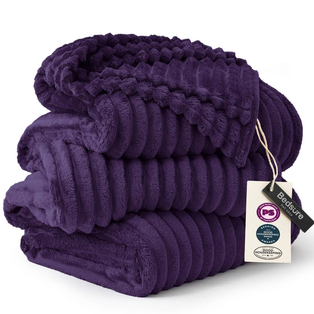 Purple fleece blanket with chunky ridged weave and rolled folded edges