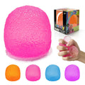 Pink squishy stress ball, 2.2 in, held in a hand with texture detail