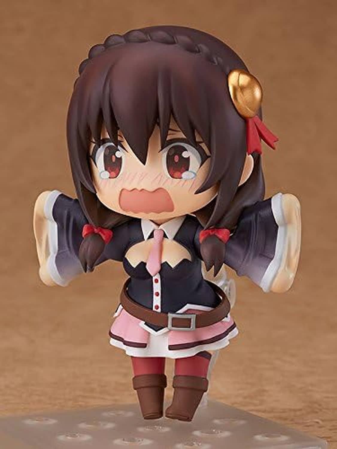 Chibi Nendoroid figure with arms extended; dark hair, red eyes, black outfit, pink skirt.
