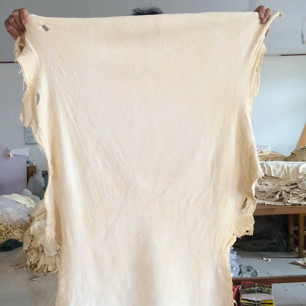 Off-white chamois leather cleaning cloth draped open, ragged edges