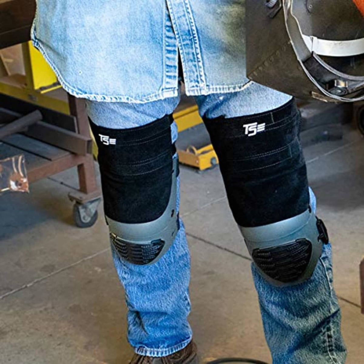 Black leather knee pads on jeans with gray protective plate at knee