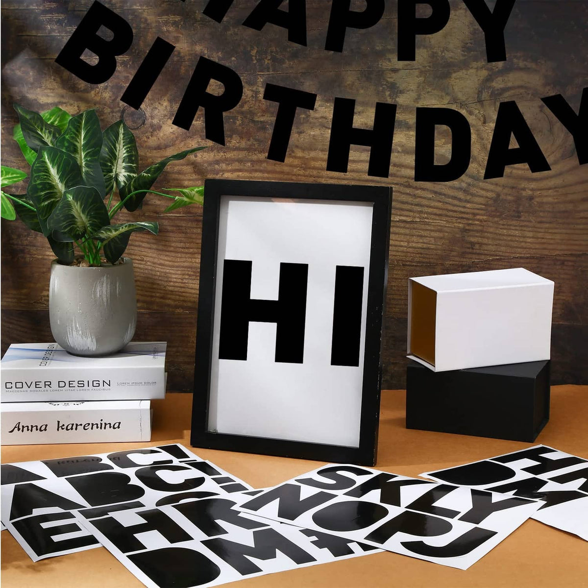 Black vinyl letter stickers spelling HAPPY BIRTHDAY across a tabletop