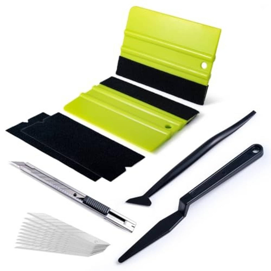 Car window tint kit with lime green felt tape, black squeegees, and edge trimming tool