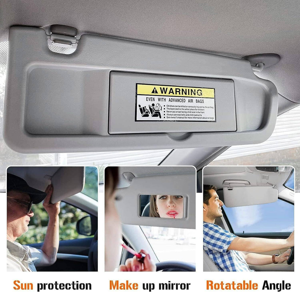 Grey right passenger sun visor with warning label and clips above windshield
