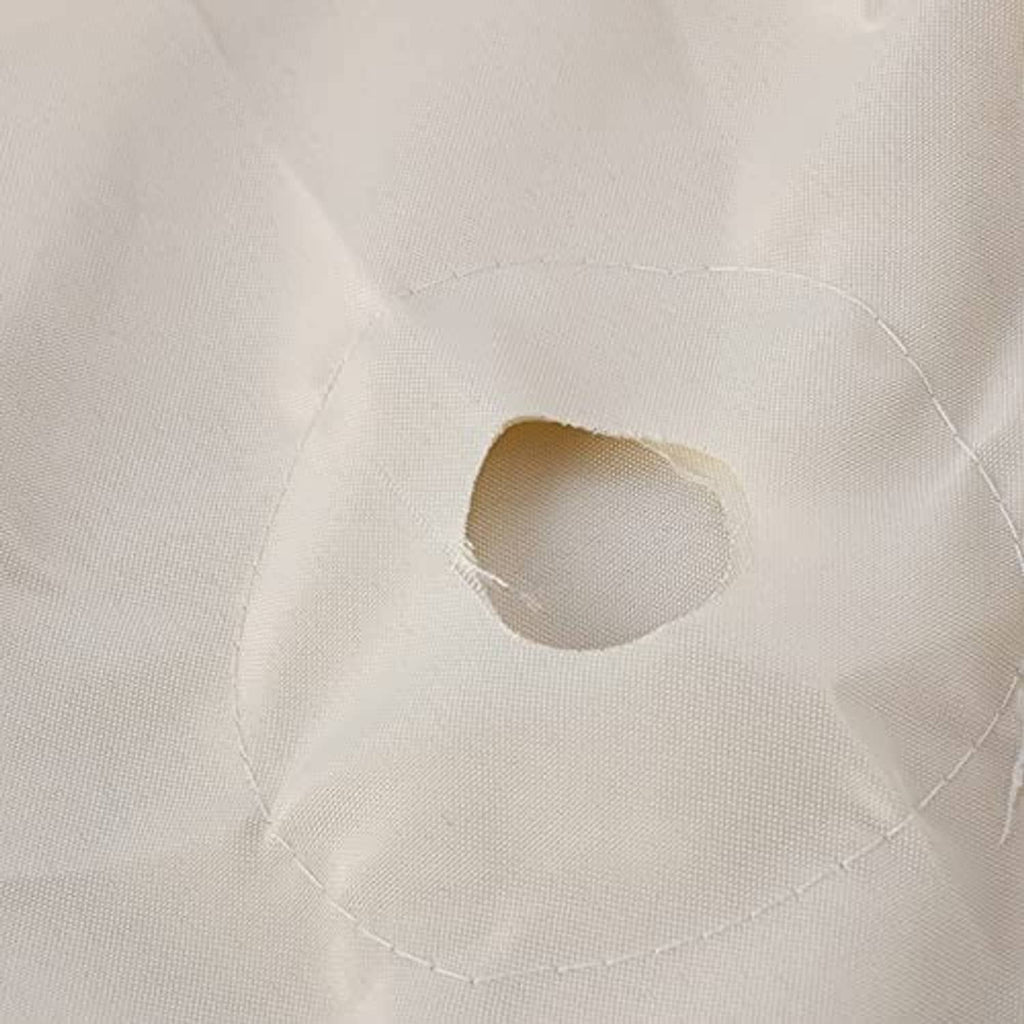 Close-up of light cream umbrella canopy underside with vent opening and stitching