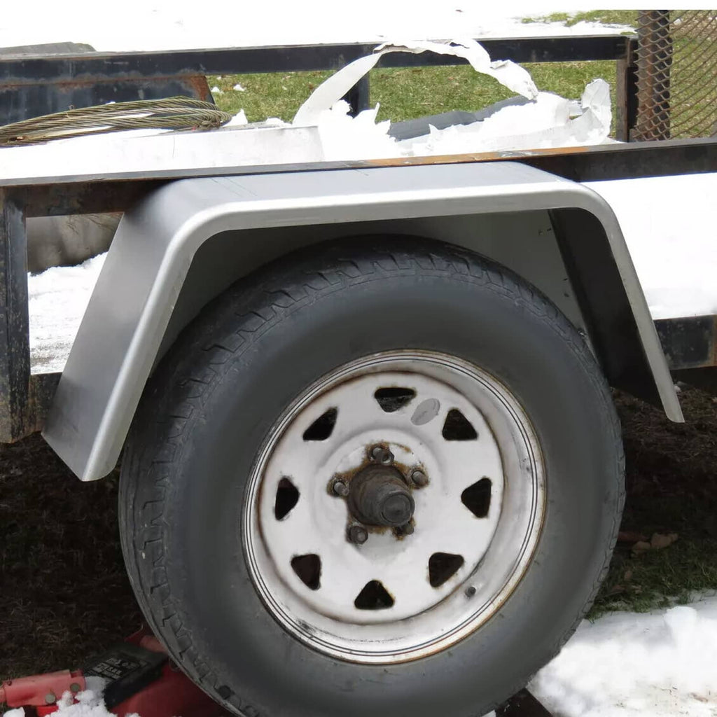 Light gray wheel fender installed over trailer tire and chrome hub cover