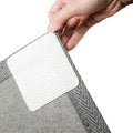 Gray rug pad gripper corner with textured surface and white non-slip backing