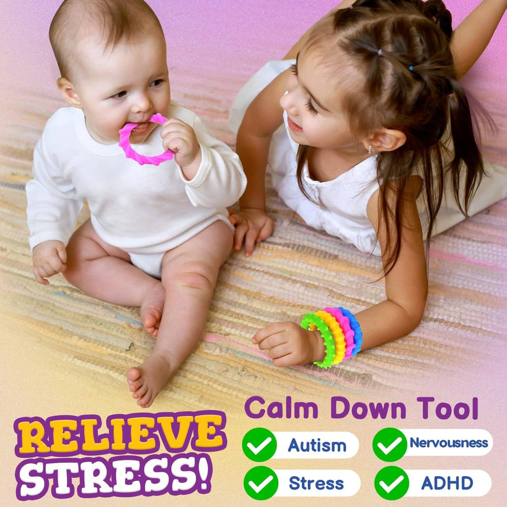 Silicone fidget bracelet for toddlers, small child holding a multicolor textured ring