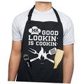 Black cotton apron with 'MR. GOOD LOOKIN' IS COOKIN' graphic and dual pockets