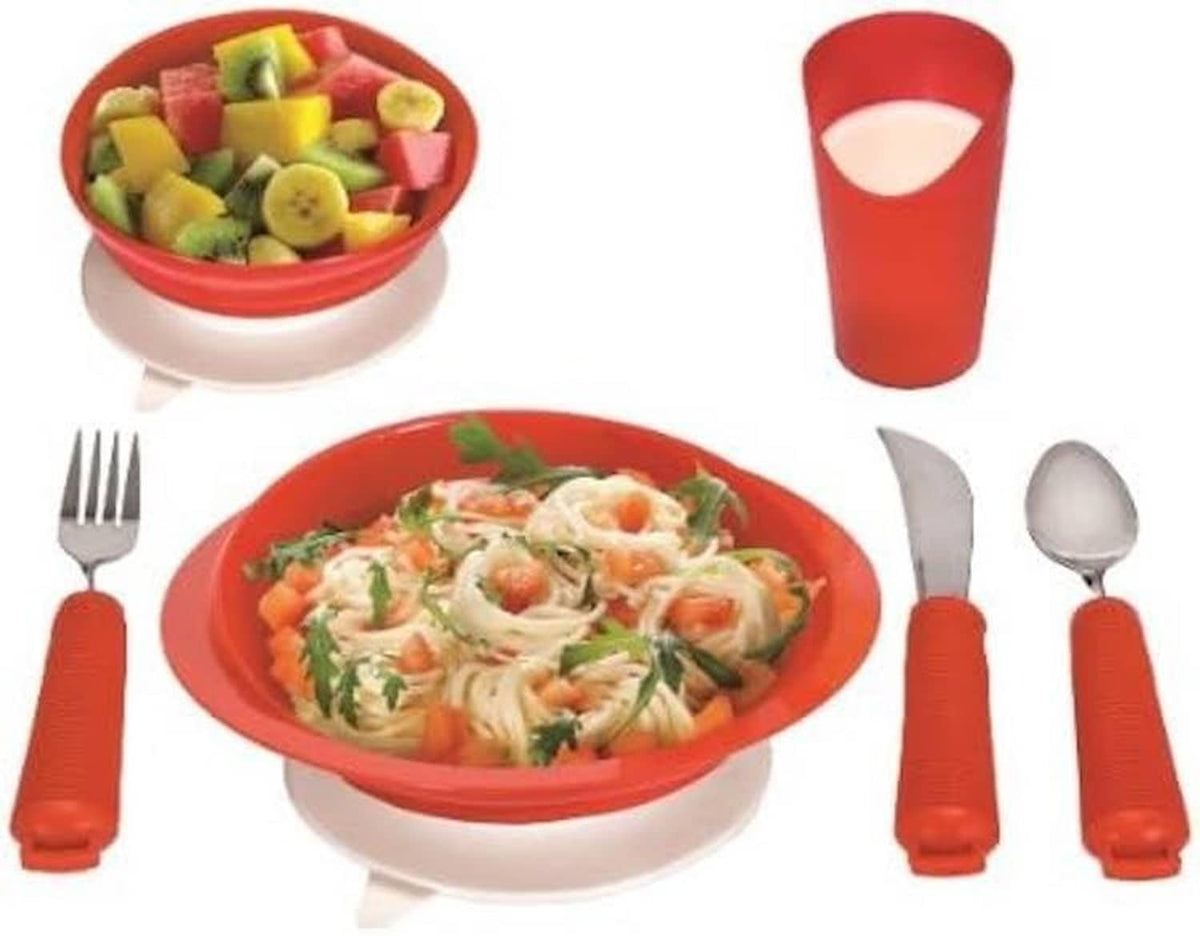 Red adaptive dinnerware serving set with food, bowl, cutout cup, and utensils